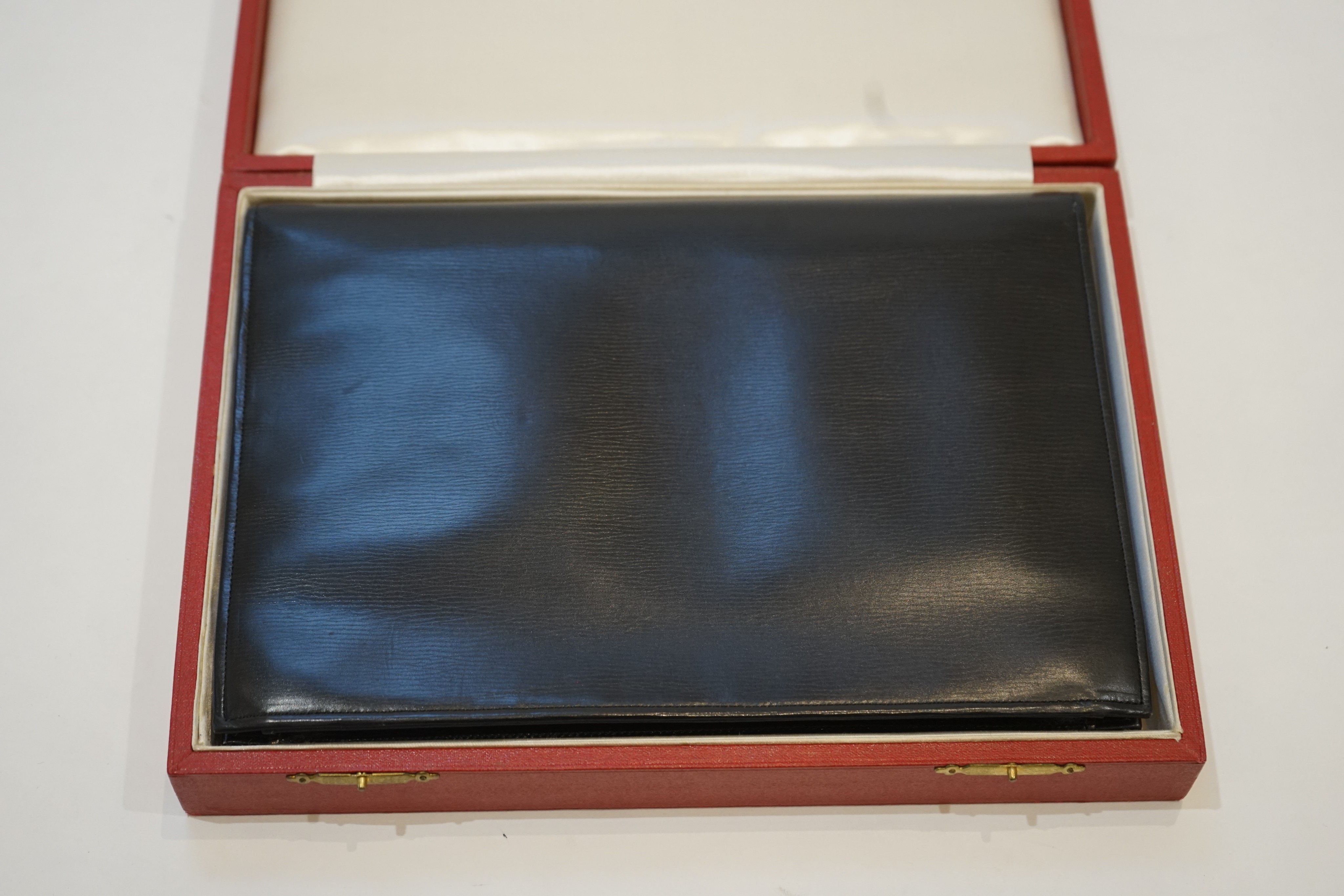 A vintage Cartier, London black leather handbag, fitted with original mirror and purse, in original box.